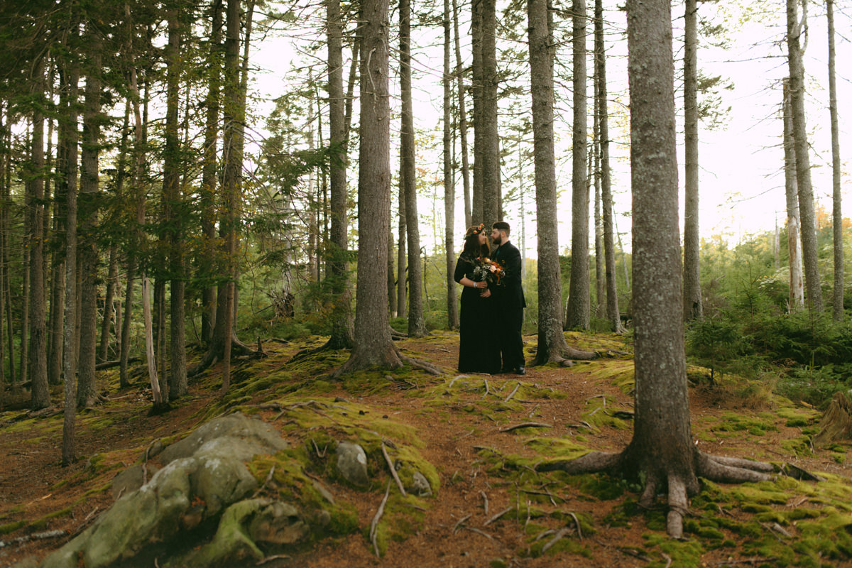 Bride and groom in Black Dress and Suit in the forest at Hatfield Farm in Hammonds Plains, NS