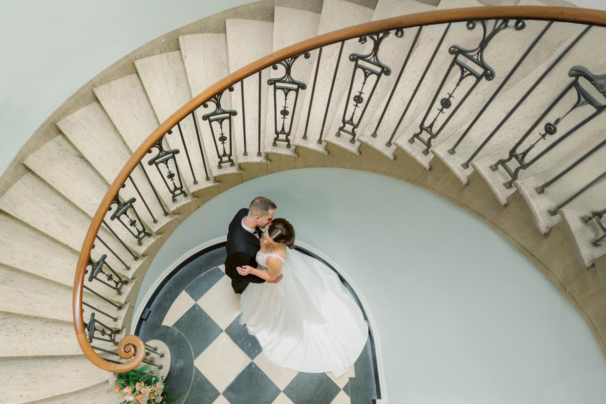 Bride and groom on spiral staircase