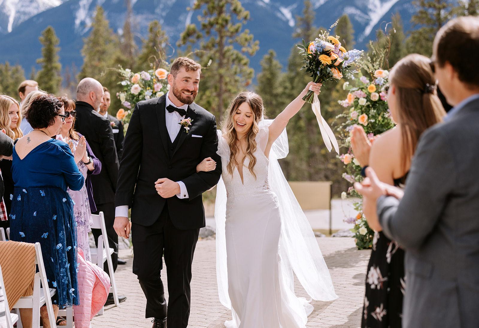 Couple walking down the aisle after the wedding ceremony at Silvertip