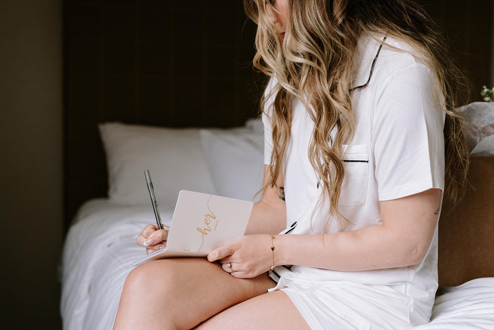 Bride writing vows in natural light at Malcolm Hotel