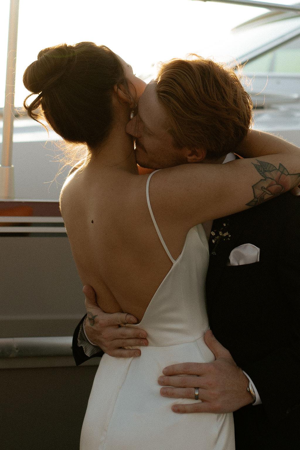 Bride and groom embrace in a romantic moment, Fox Harb'r, NS