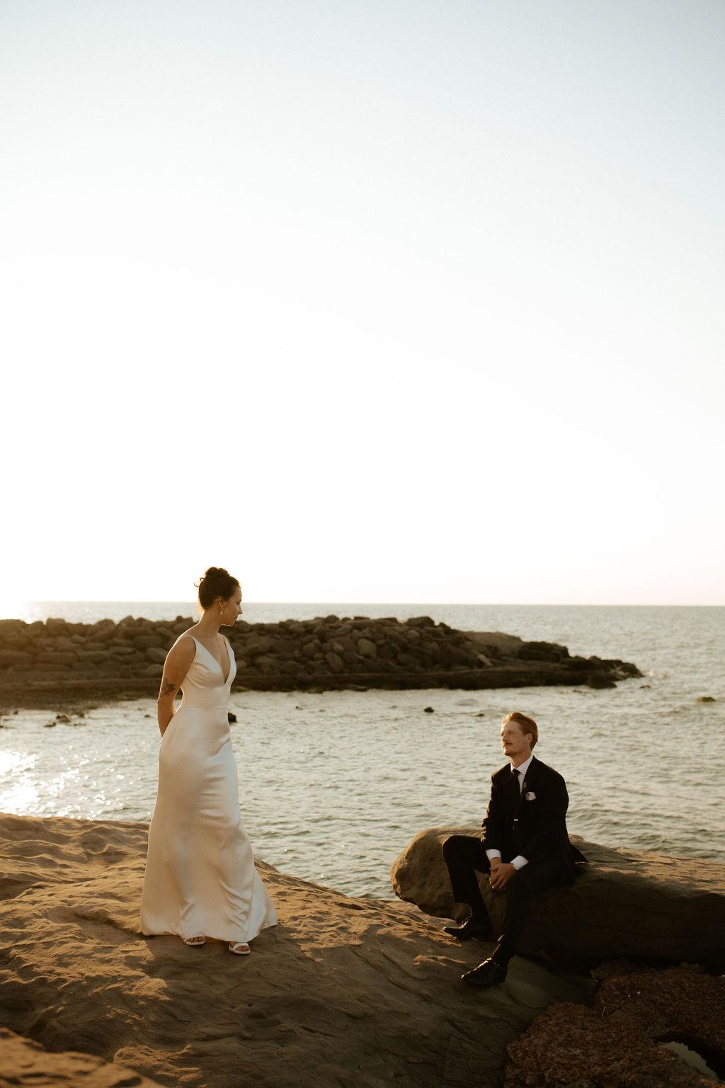Couple posed on the oceanside at Fox Harb'r resort, Nova Scotia