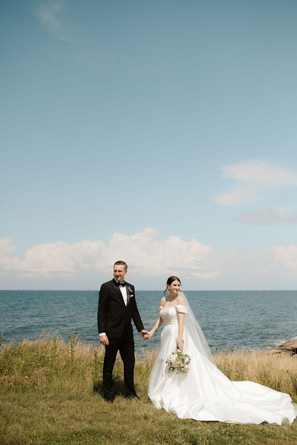 Bride and groom pose along the Northumberland Strait, Fox Harb'r, Nova Scotia