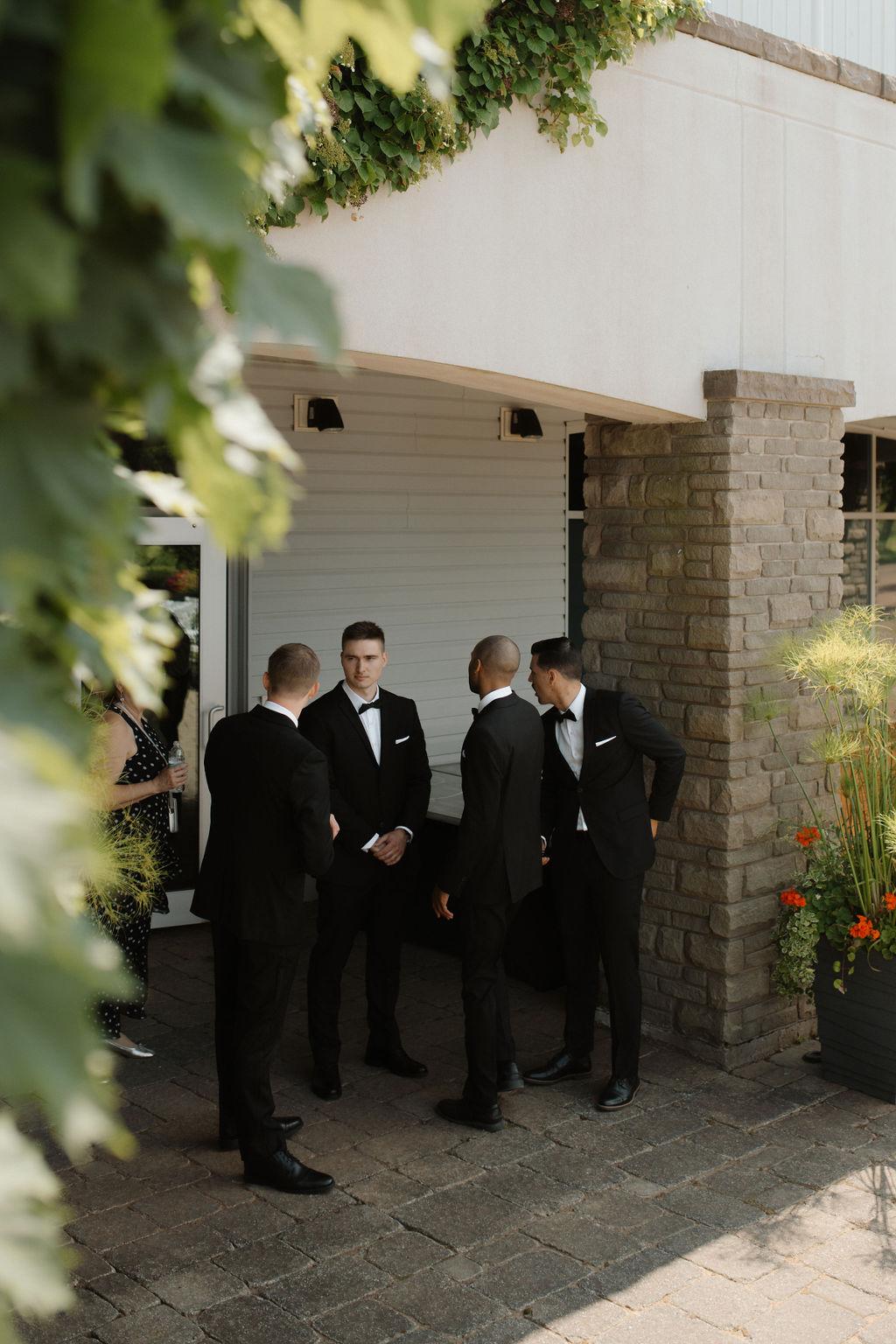 Groomsmen gather before wedding ceremony, Fox Harb'r resort, Nova Scotia