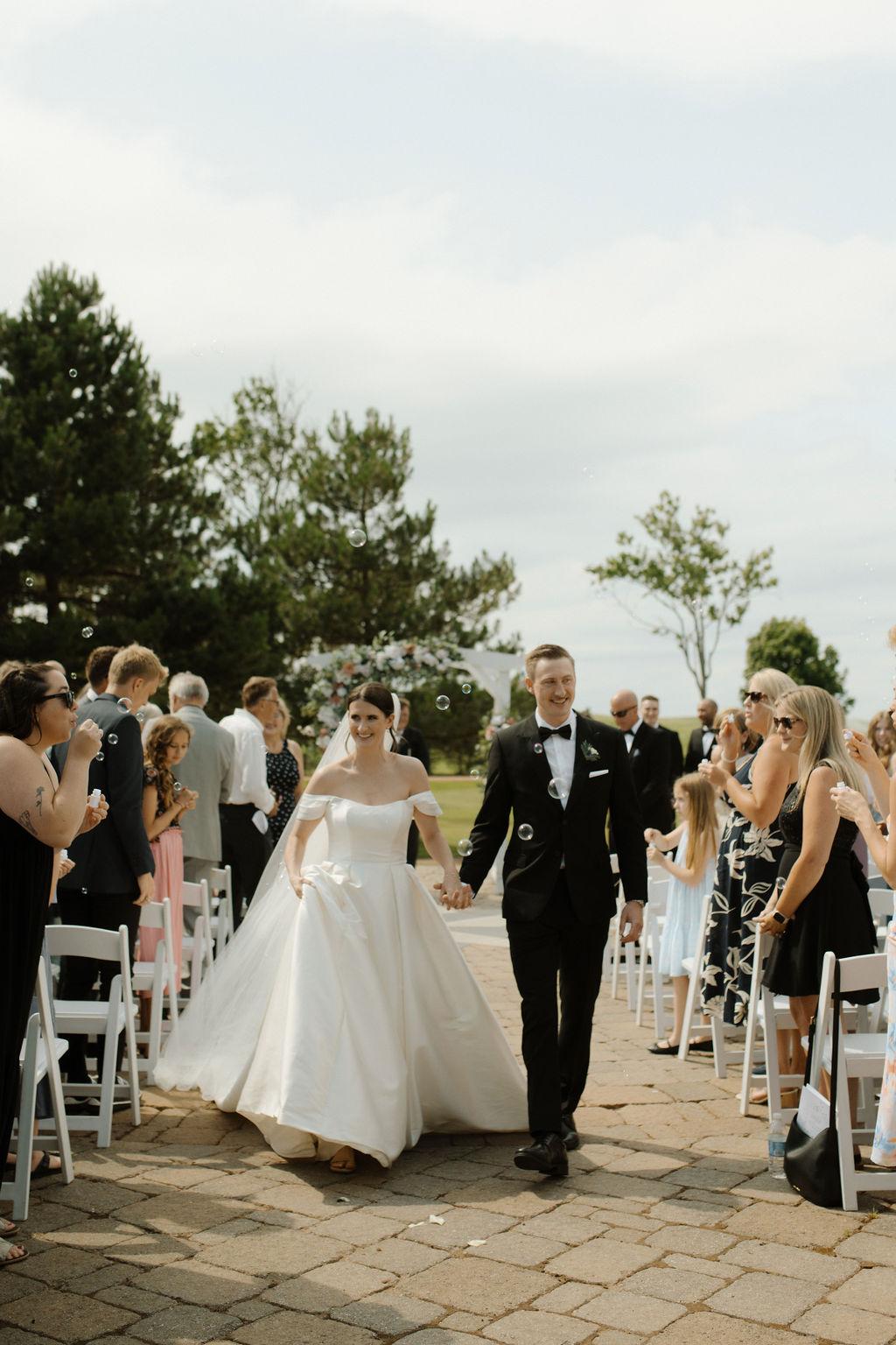 Bride and groom walking down the aisle after getting married, Fox Harb'r, Nova Scotia