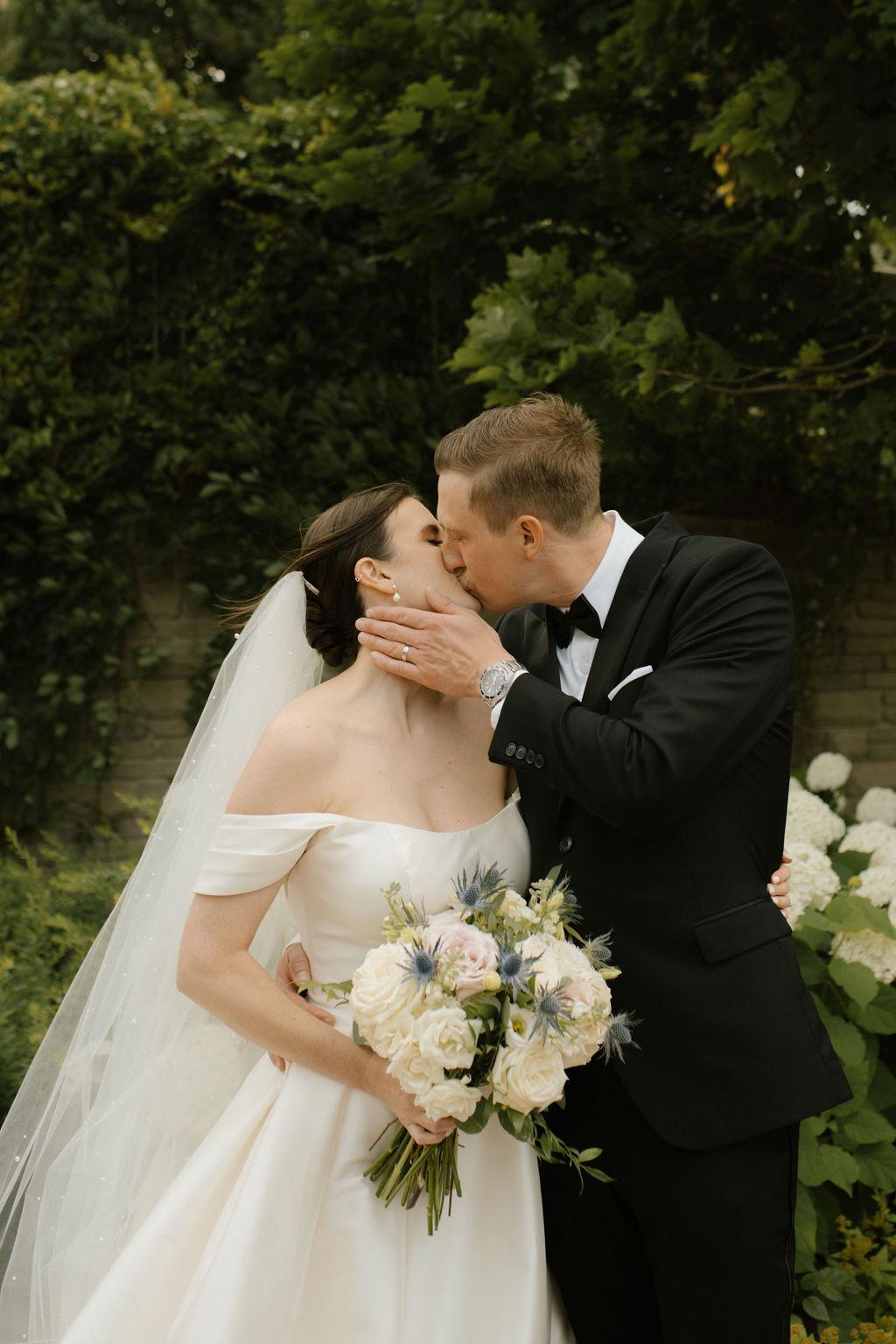 Bride and groom kiss on wedding day, Fox Harb'r, Nova Scotia