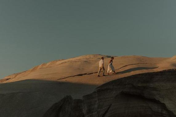 Cinematic couple walking in a desert scene, kelowna