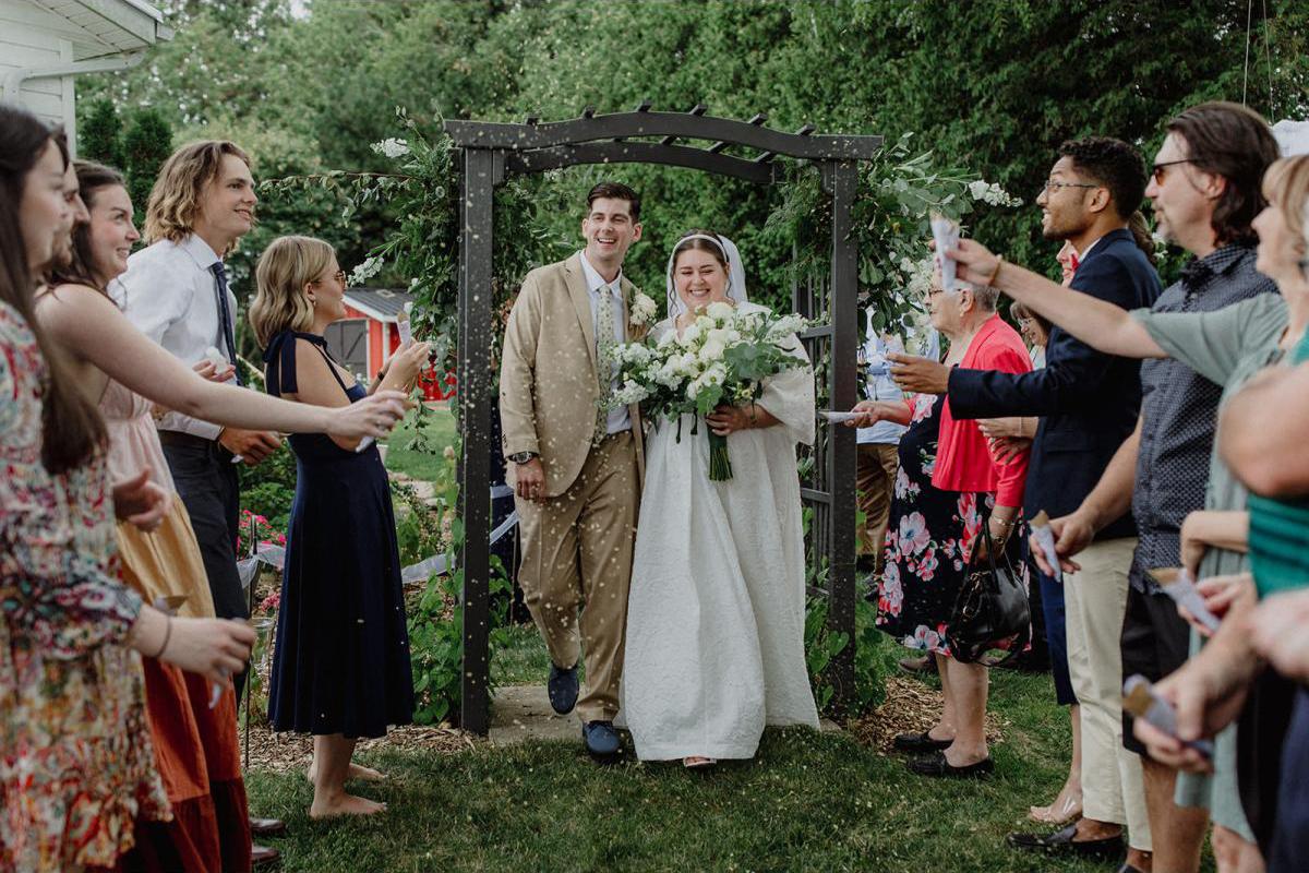 Couple walking down the altar after their wedding ceremony, confetti in the air