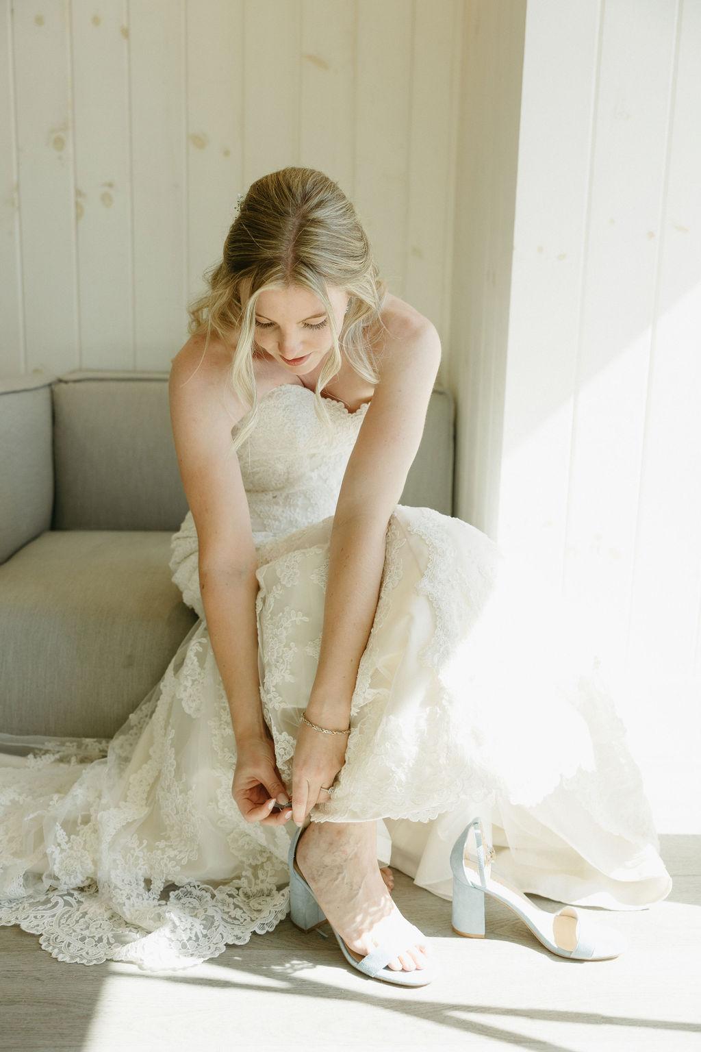 Bride putting on wedding shoes at Oceanstone Resort