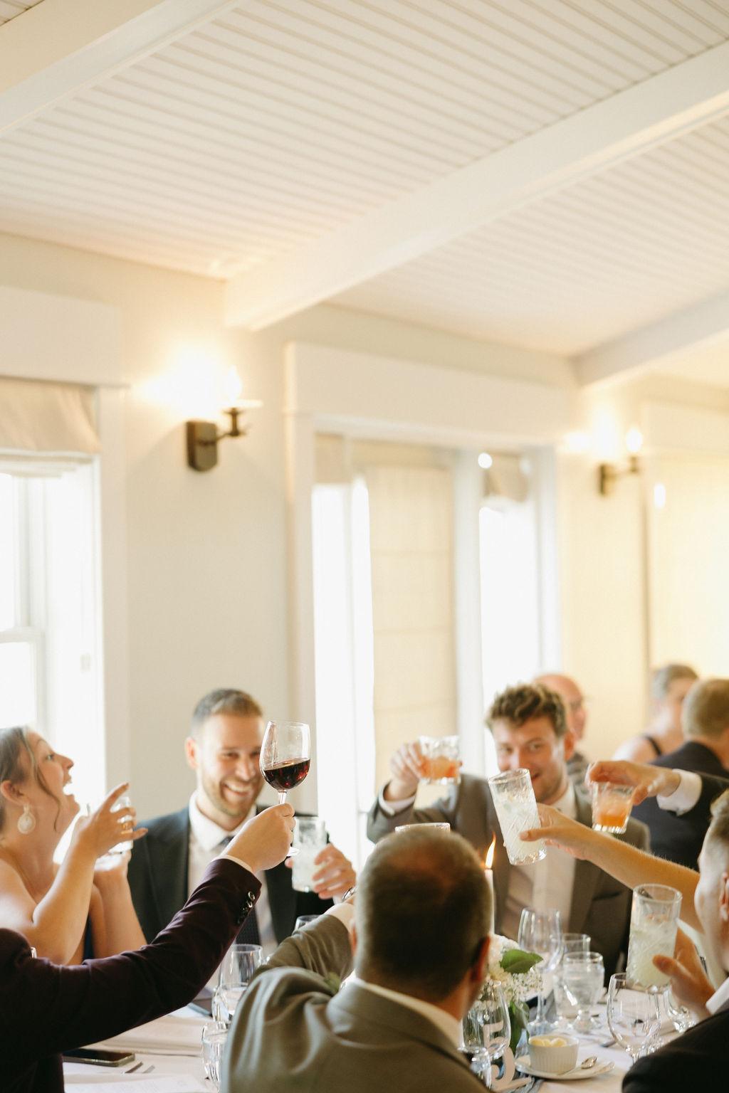 Guests at wedding reception cheers