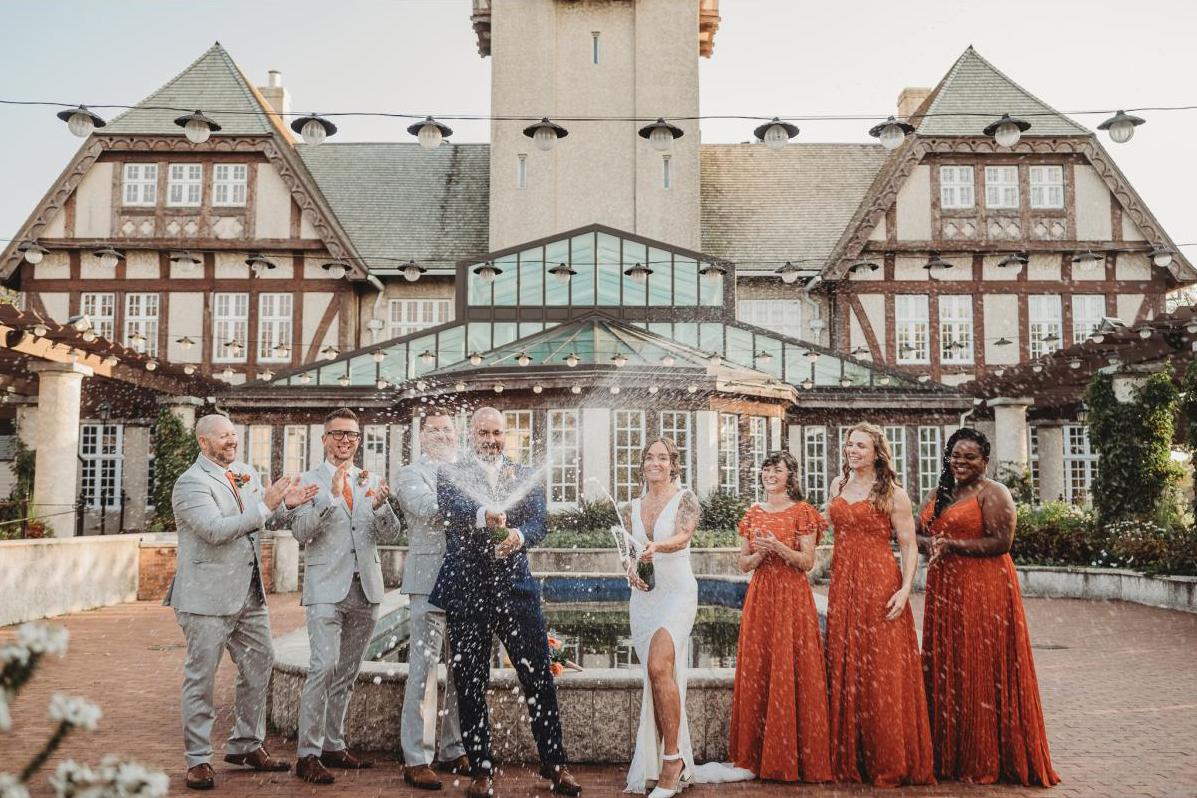Wedding party spraying champagne at Assiniboine park pavilion