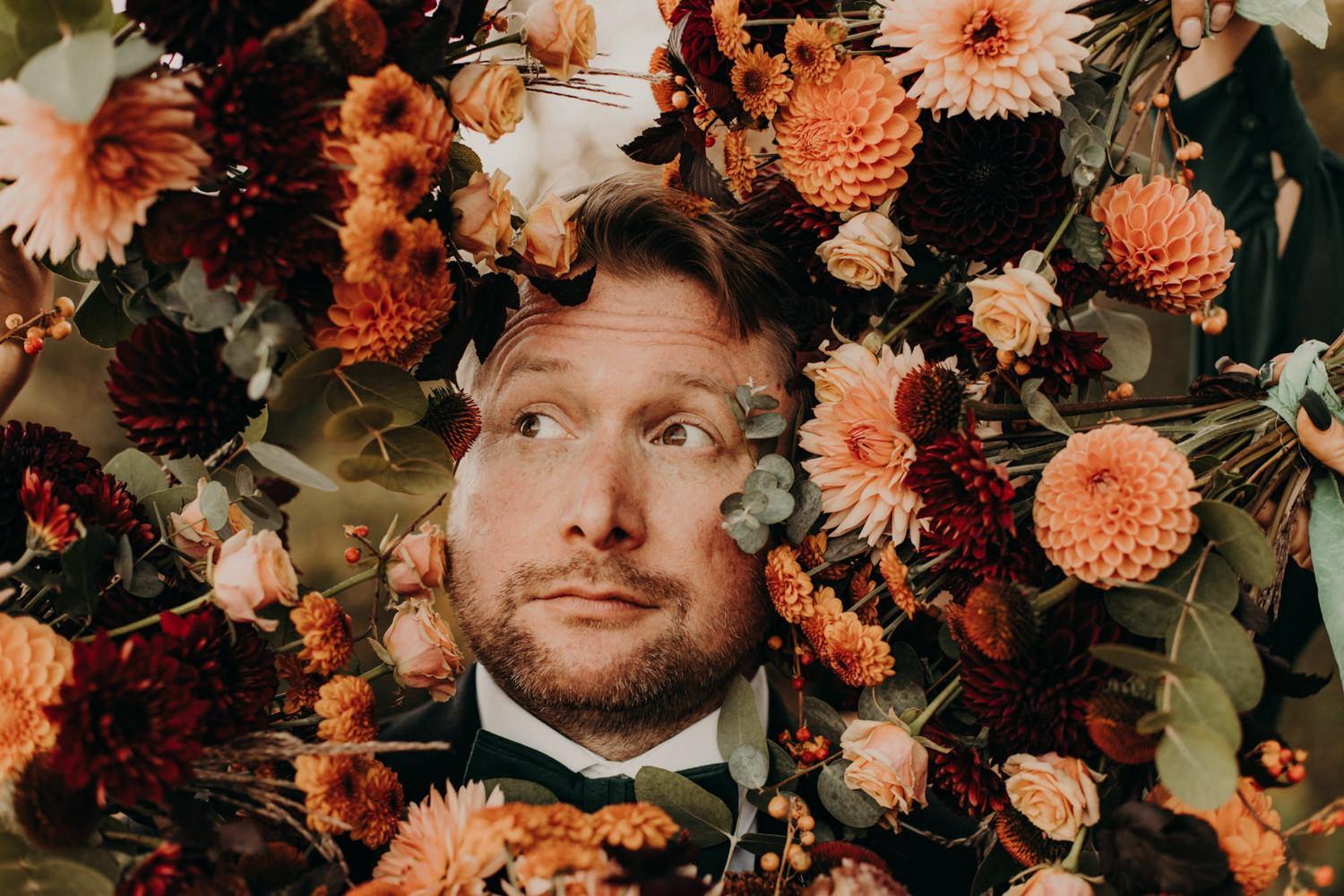 Groom surrounded by bouquets, Vancouver Island