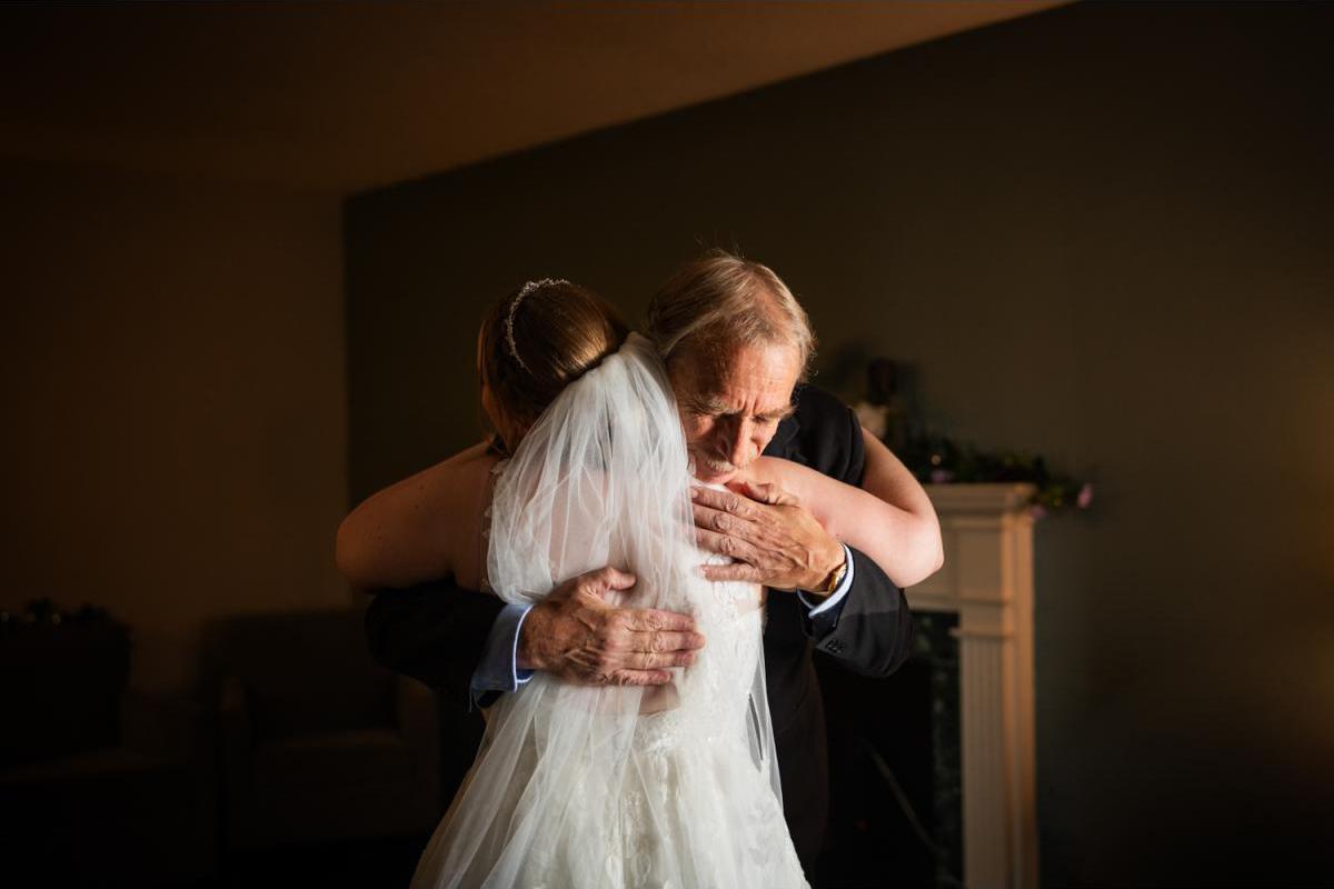 A Father hugs bride at wedding