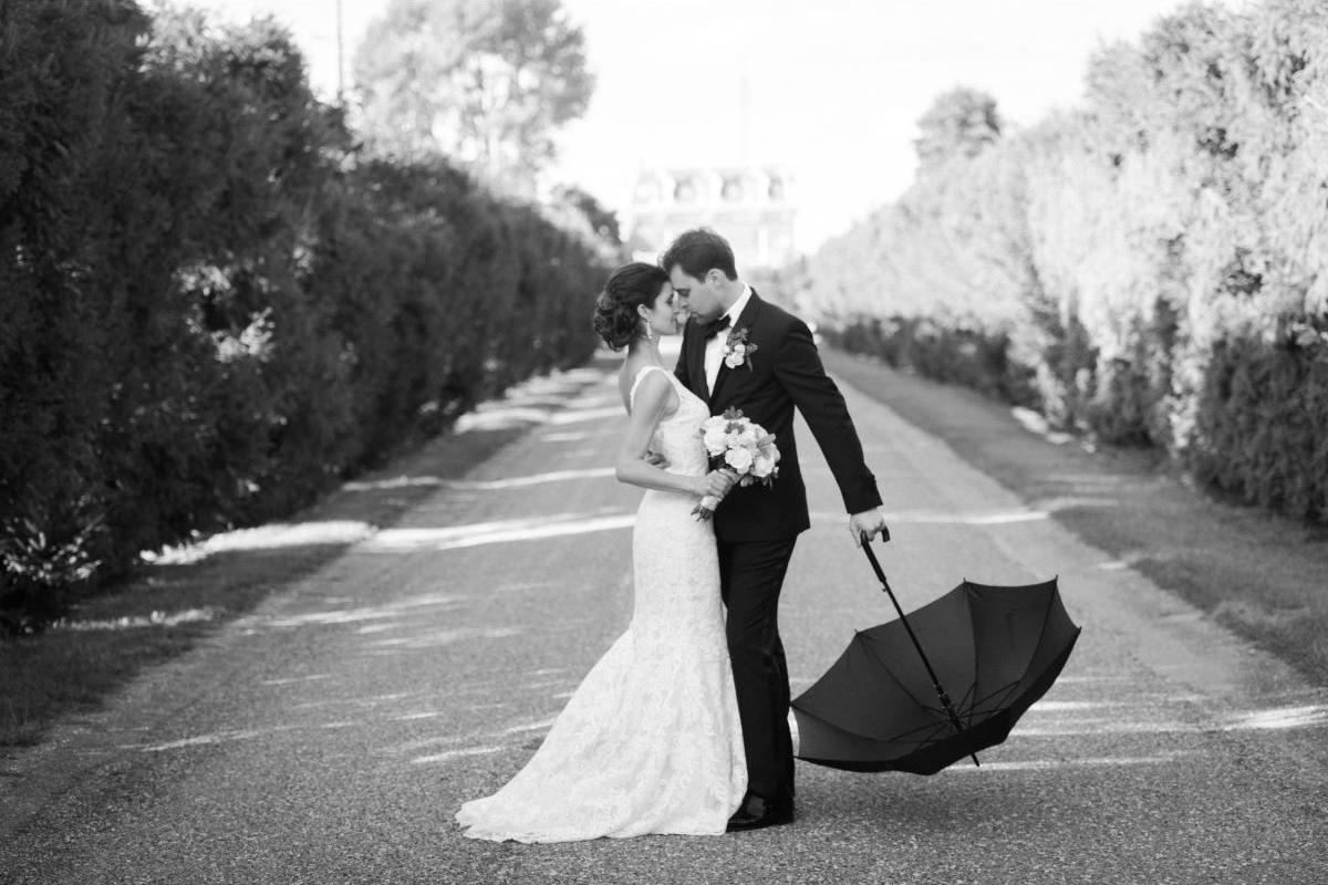 A classic elegant photo of a bride and groom holding umbrella, windsor, ontario