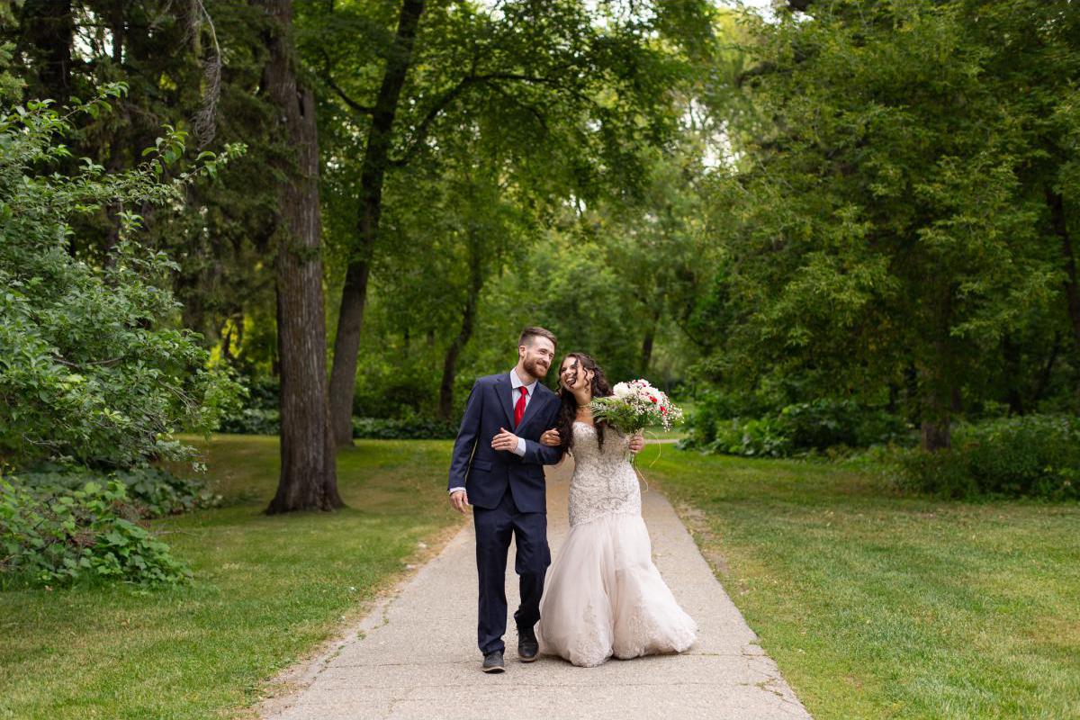 Bride and Groom walking in forest