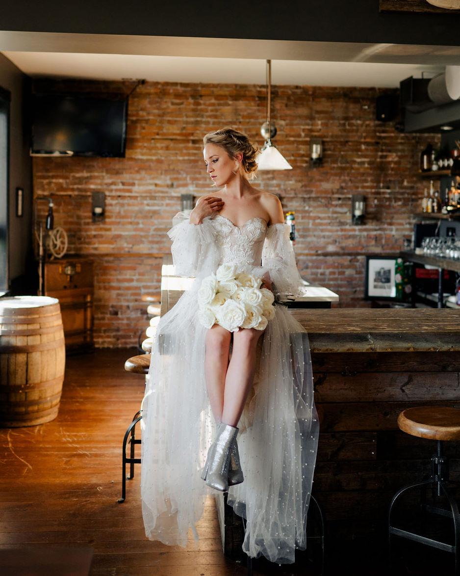 Bride sitting on bartop at Lake of the Woods Brewing Company, Amanda Longe