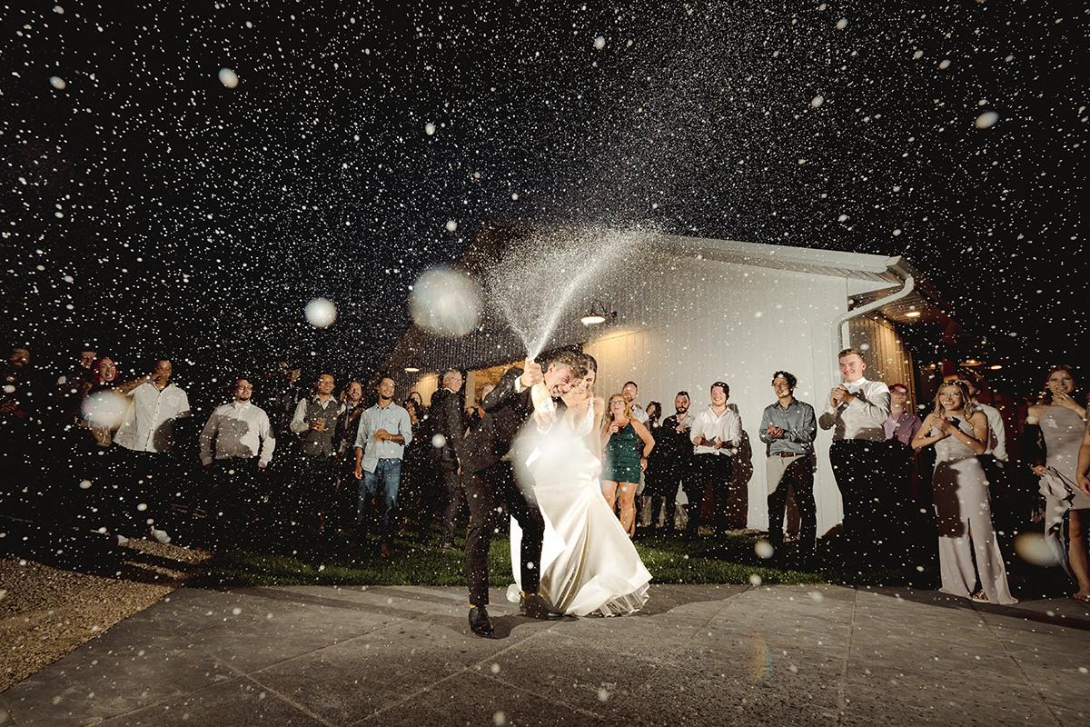 Champagne pop by Husband and Wife Wedding Photographers Black & Gold Photography in Winnipeg