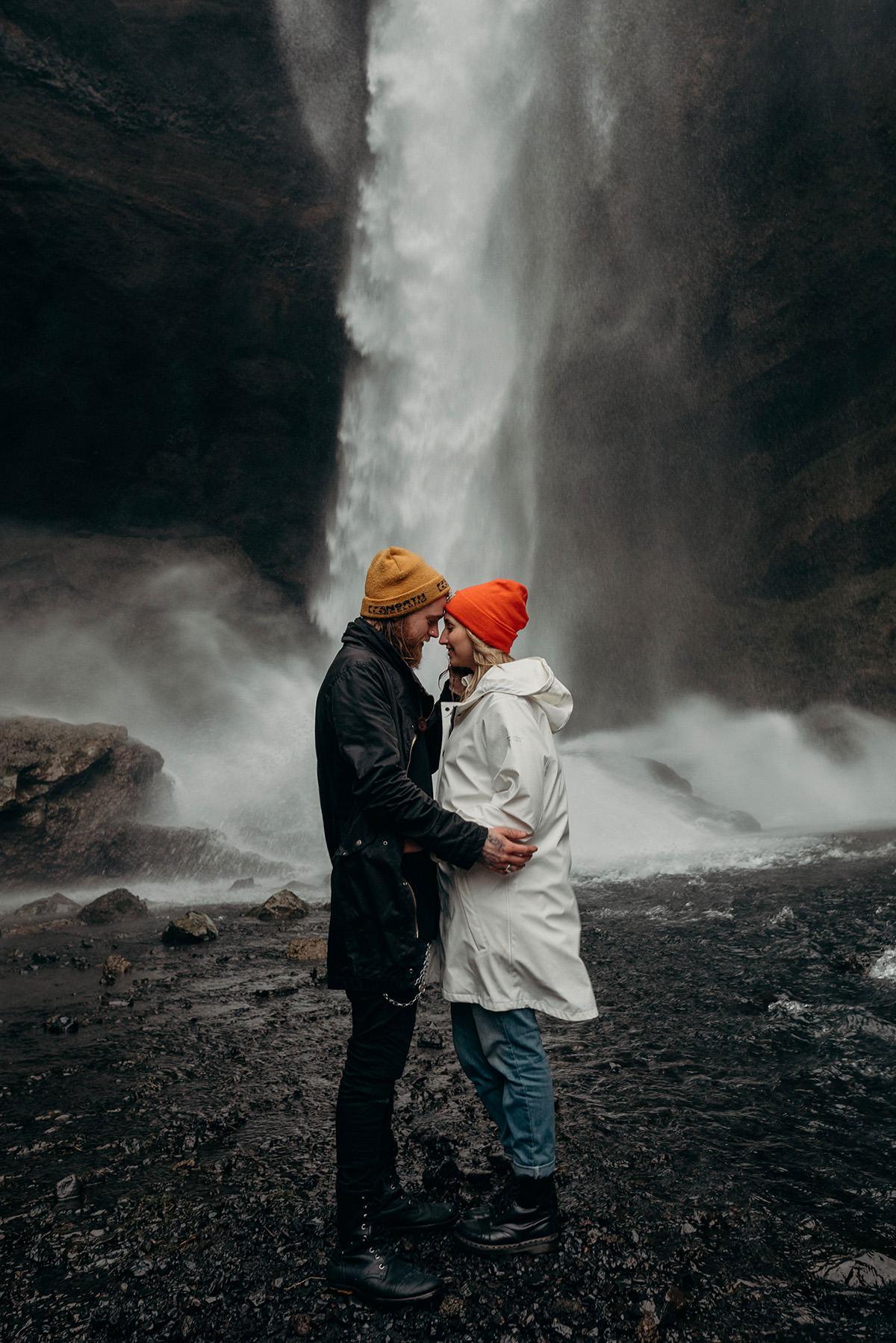 Couple embracing under a waterfall in Iceland, elopement photography